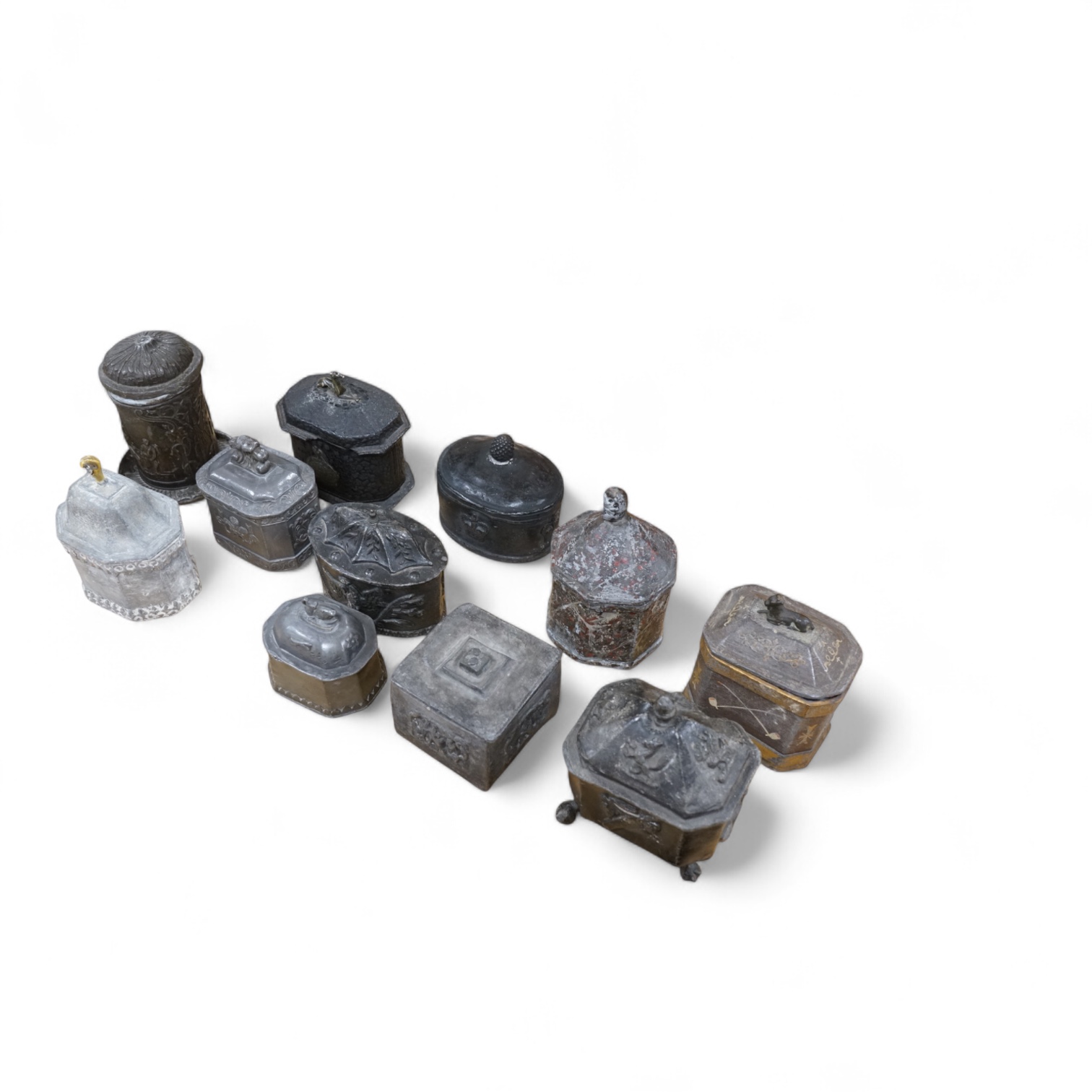 A collection of eleven early 19th century lead tobacco boxes to include an octagonal example with remains of red paint, largest 13cm wide